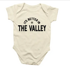 Beige baby onesie with 'It's Better in The Valley' text on a white background