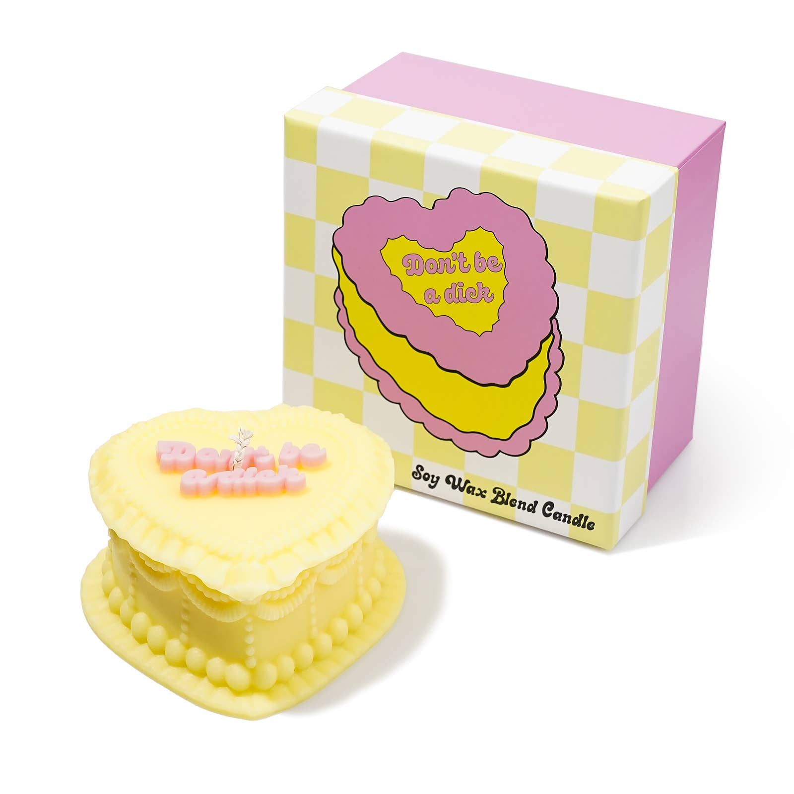 Yellow cake-shaped candle with 'Don't be a dick' text next to its checkered box packaging.